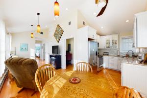 a kitchen and living room with a table and chairs at Eastwind Elegance in Ogunquit
