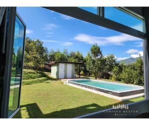 a view from the window of a house with a swimming pool at Campson Heaven Resort in Khao Kho