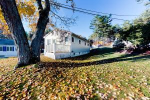 a house in a yard with a tree and leaves at Eastwind Elegance in Ogunquit