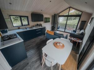 a kitchen and living room in a tiny house at Briarfield Farm Stays - A Unique Coastal Getaway in Glenarm