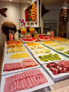 a buffet with many different types of fruits and vegetables at Belle Arti Pousada in Florianópolis