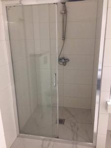 a shower with a glass door in a bathroom at Apartament IGA in Biała Podlaska