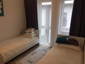 Łóżko lub łóżka w pokoju w obiekcie Apartament IGA