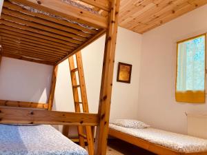 a bedroom with two bunk beds and a window at Lac De Cancon in Cancon