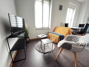 a living room with a couch and a chair at Mon Spacieux Studio Parking Un-Séjour-à-Part in Saint-Julien-lès-Metz