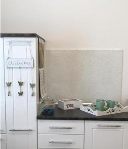 a kitchen with white cabinets and a white refrigerator at Apartment Top Diplomat in Prague