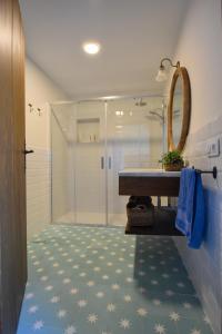 a bathroom with a shower and a sink and a mirror at Finca Santa Maria de las Cañadas in El Garrobo