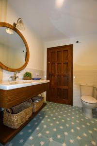 a bathroom with a sink and a mirror and a toilet at Finca Santa Maria de las Cañadas in El Garrobo +38 photos