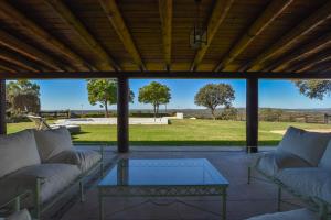 a living room with couches and a glass table at Finca Santa Maria de las Cañadas in El Garrobo