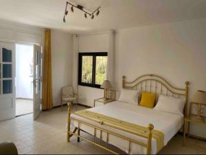 a bedroom with a large bed with yellow pillows at TérangaLux Collection Villa Green House Mamelles in Dakar
