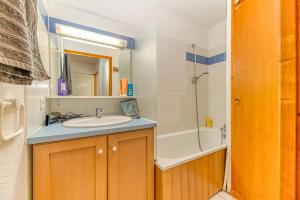 un baño con lavabo y bañera en Les Balcons du Soleil 4013, en Les Deux Alpes 19 fotos más