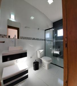 a bathroom with a toilet and a sink and a shower at BALNEÁRIO GAIVOTA no AREIAS CLARAS in Sombrio