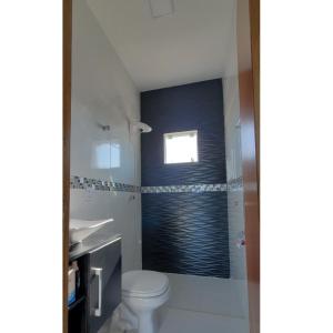 a bathroom with a shower with a toilet and a window at BALNEÁRIO GAIVOTA no AREIAS CLARAS in Sombrio
