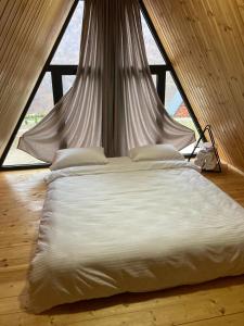 a large bed in a room with a window at Green Villa Resort Grey in Dilijan