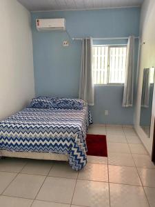 ein kleines Schlafzimmer mit einem Bett und einem Fenster in der Unterkunft Rancho Lisboa Cocal in Queimada