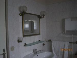 a bathroom with a sink and a mirror at Les Chênes 2 - cadre verdoyant in Eugénie-les-Bains