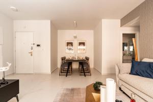 a living room with a table and a couch at Central and Luxury New 2BR&2Bth - Private Parking in Jerusalem