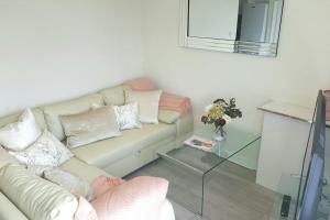 a living room with a couch and a glass table at Large 6 bedroom duplex - perfect for large family in Liverpool