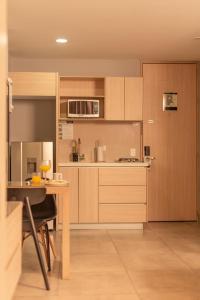卡利的住宿－Antope - Apartaestudios，一个带木制橱柜和桌子的厨房