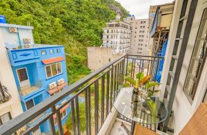 a balcony with a glass table with a view at Mountain Pearl Hotel in Cat Ba