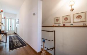 a hallway with white walls and a staircase with a rug at Nice Apartment In Verucchio With Kitchen in Verucchio