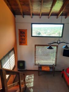 a room with a window and a couch in a room at MiraSierras -casas vacacionales- in Villa General Belgrano