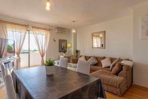a living room with a table and a couch at 797 Holiday Rentals - Espacioso apartamento para 6 en torremolinos in Torremolinos