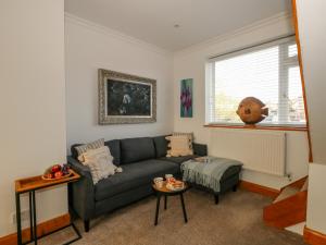 a living room with a couch and a table at Winterslow in Weymouth