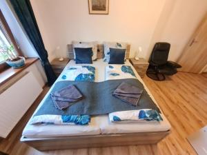 a bedroom with a large bed with blue pillows at Malebný Rodinný Dům v Přírodě, Sauna, BBQ in Třinec