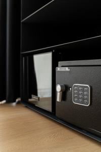 a black microwave oven sitting on top of a wooden floor at Plebiscito Boutique Rooms in Naples