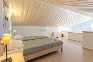a bedroom with a large bed and a wooden ceiling at Nafsika Beach House in Dhamoulianáta