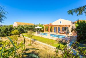 a villa with a swimming pool and a house at Nafsika Beach House in Dhamoulianáta