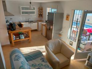 a kitchen and living room with a couch and a refrigerator at Villa MATHEO in Bolnuevo