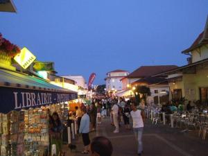 a crowd of people walking down a street at night at A 200m de la plage - L'Océan - in Mimizan-Plage
