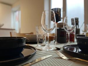 a table with wine glasses and plates on it at City apartment mini-spa in Tallinn