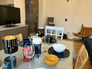 a table with plates and wine glasses on it at City apartment mini-spa in Tallinn