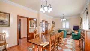 a dining room and living room with a table and chairs at Hacienda la Toscana Priego de Córdoba by Ruralidays in Priego de Córdoba