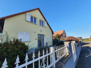 a white fence in front of a house at Ô calme Maison familiale - Wickerschwihr in Wickerschwihr