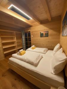 a bedroom with two beds in a wooden cabin at Jagdhütte in Lachtal