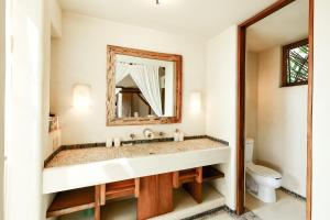 a bathroom with a sink and a mirror at Beautiful Family House Beachfront in La Unión +37 photos