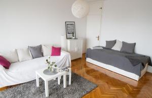 a living room with a couch and a bed at Relax Central Apartment in Zagreb