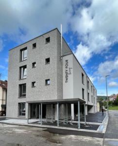 un gran edificio de ladrillo en el lateral de una calle en Hotel TwentyFour Living en Bad Urach