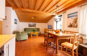 a kitchen and living room with a wooden ceiling at Haus Herz in Haus im Ennstal