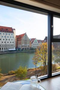 a window with a view of a river and buildings at Elite Apartments Rezydencja Wintera in Gdańsk