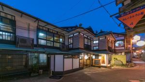 a building with a lot of balconies on a street at Kyukamura Oku-Daisen in Daisen