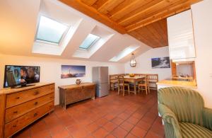 a kitchen and living room with skylights and a television at Haus Herz in Haus im Ennstal