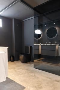 a bathroom with a toilet and a sink and mirrors at MAESTRANZA MODERN y LUXURY in Seville