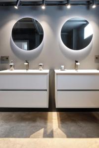a bathroom with two sinks and two mirrors at MAESTRANZA MODERN y LUXURY in Seville