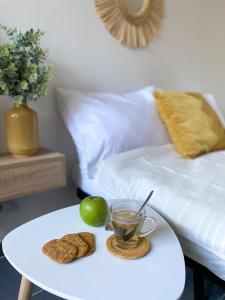 a table with a cup of tea and cookies on it at Studio 24m² Montpellier - Hôpitaux facultés Centre in Montpellier