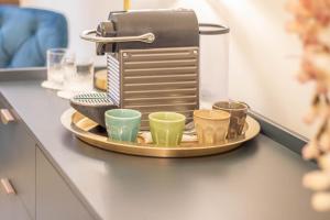 a coffee maker on a tray with cups on a counter at DANY GUEST HOUSE in Rome